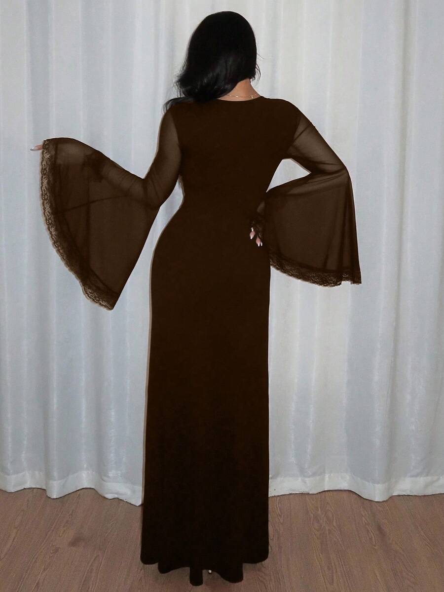 Women's slim-fit long goth dress in black featuring a deep V-neckline, extra-long flared sleeves, and a split thigh detail.