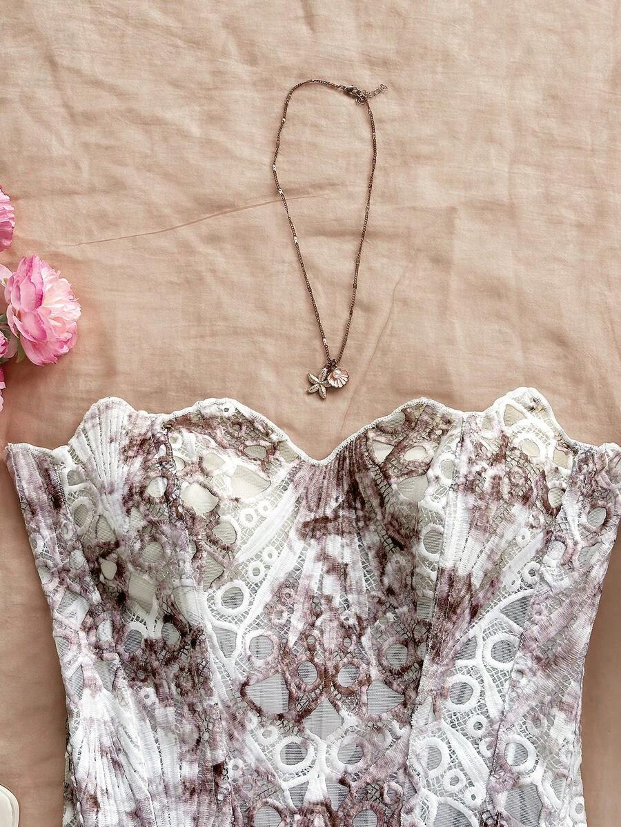Strapless floral lace corset top with lace-up detail, asymmetrical hem, and slim fit for women.