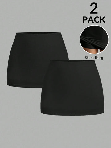 Women's black casual low rise bodycon mini skort with built-in shorts in knitted plain stretch fabric.