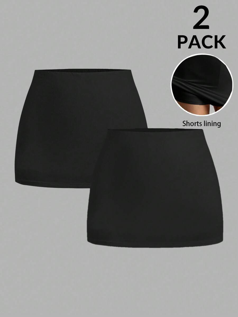 Women's black casual low rise bodycon mini skort with built-in shorts in knitted plain stretch fabric.
