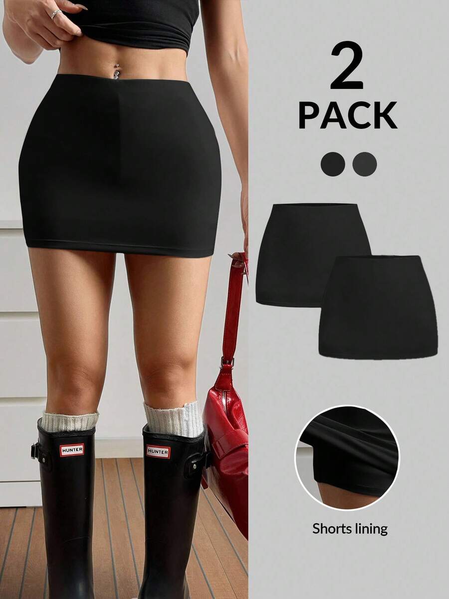 Women's black casual low rise bodycon mini skort with built-in shorts in knitted plain stretch fabric.