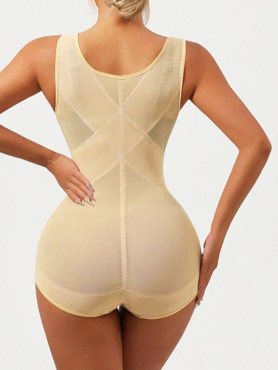 Apricot semi-sheer mesh shapewear bodysuit for women featuring a low-cut neckline, bust support, contrast mesh details, and Bermuda shorts length.