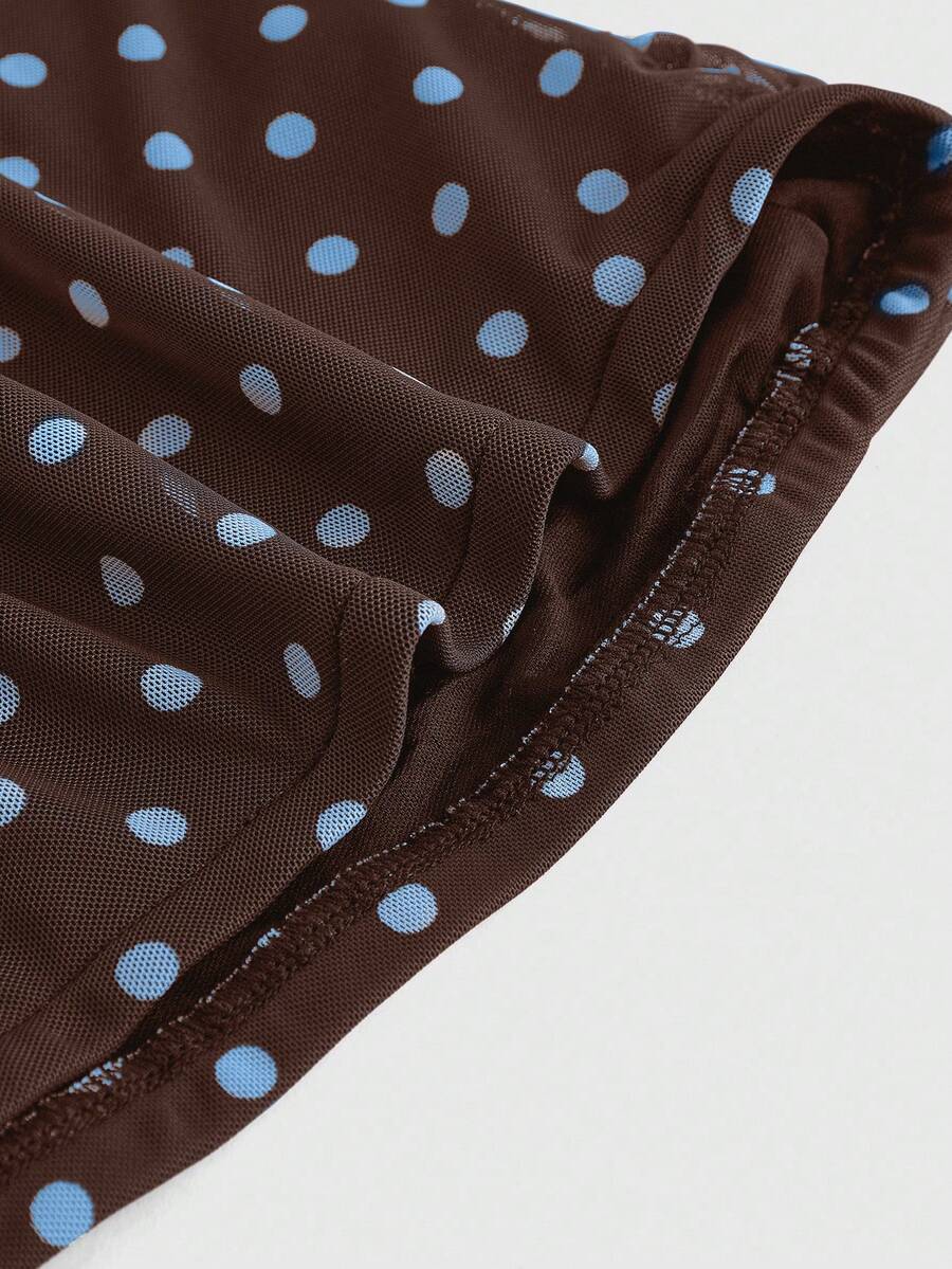 Women's black polka dot strapless tube top made of ruched mesh fabric featuring an asymmetrical hem and matching scarf.