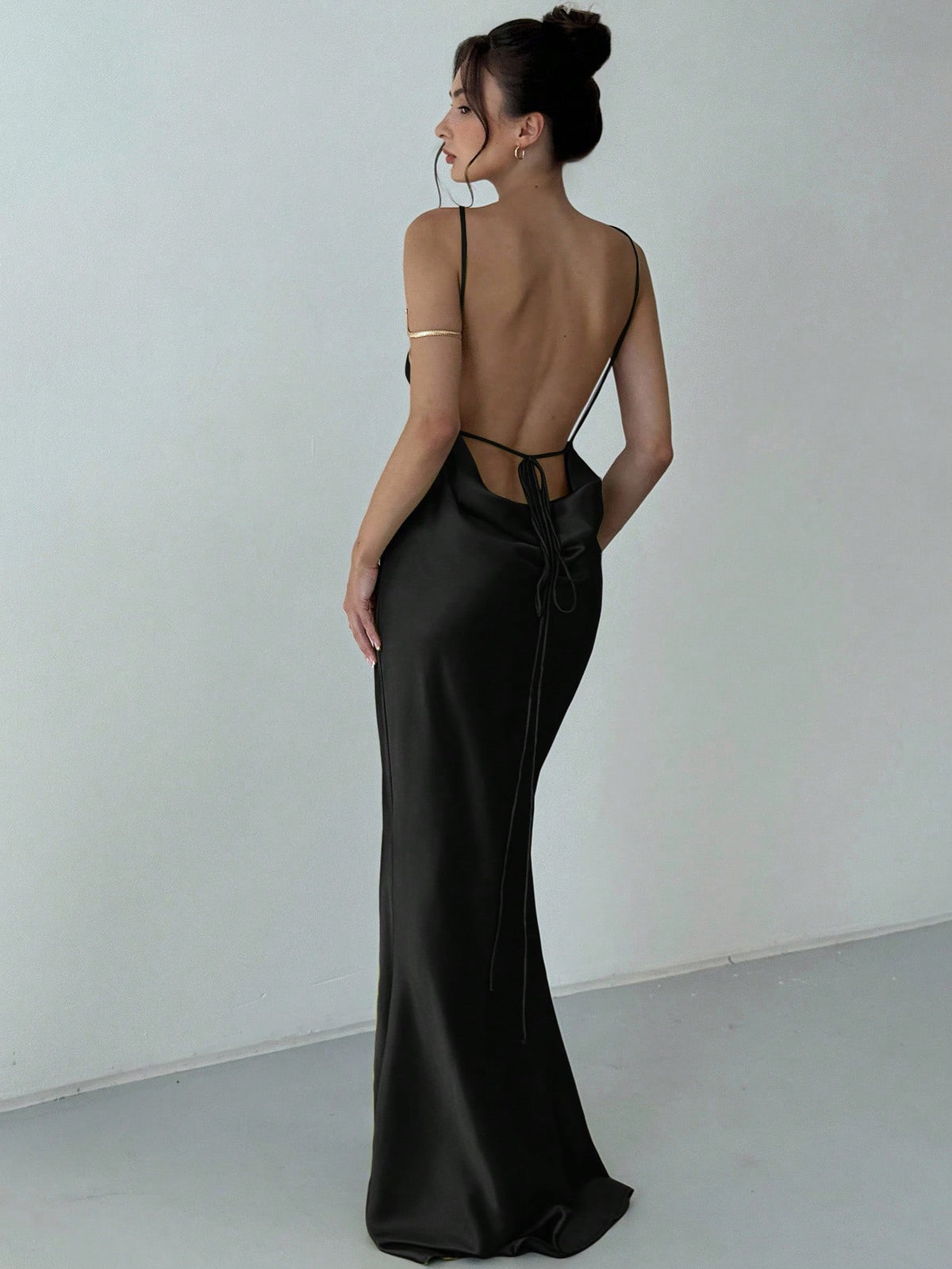 Beige satin backless maxi dress featuring criss-cross spaghetti straps and a mermaid hemline.