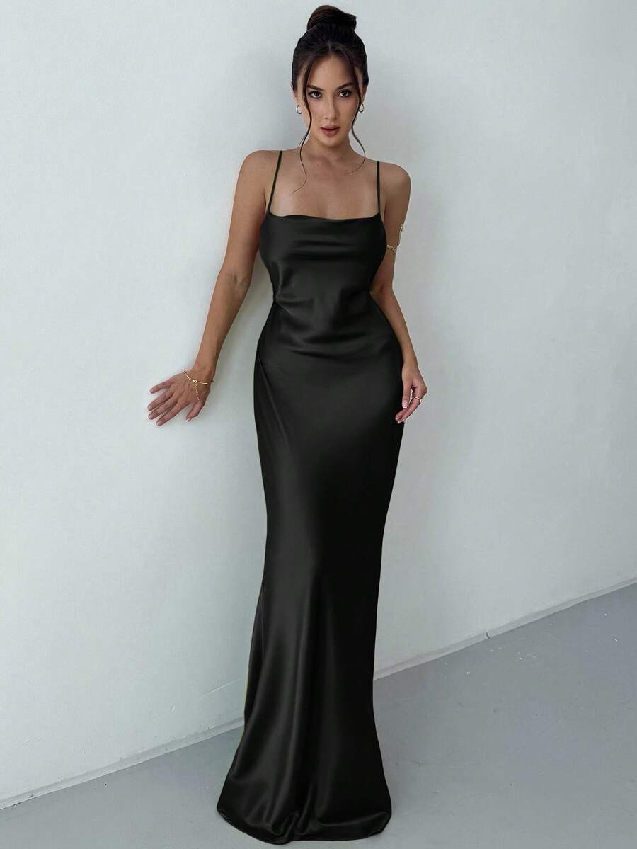 Beige satin backless maxi dress featuring criss-cross spaghetti straps and a mermaid hemline.