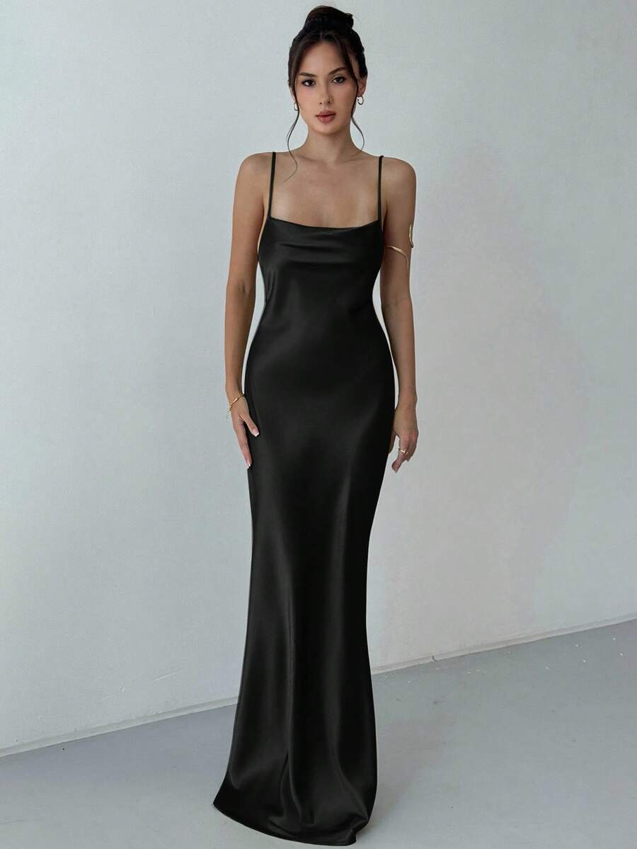 Beige satin backless maxi dress featuring criss-cross spaghetti straps and a mermaid hemline.
