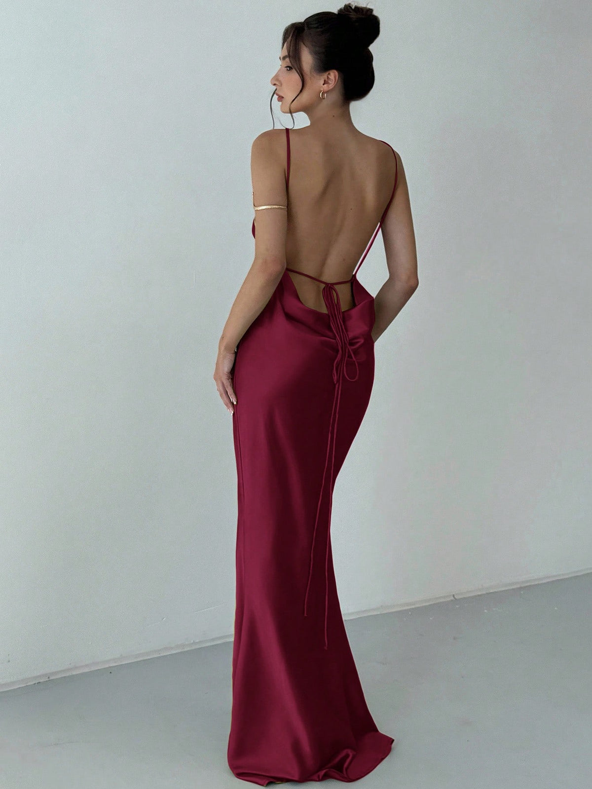 Beige satin backless maxi dress featuring criss-cross spaghetti straps and a mermaid hemline.