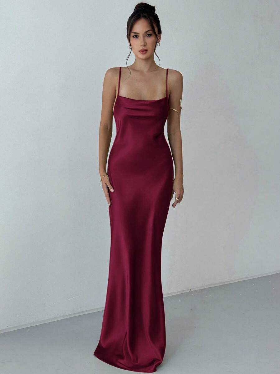 Beige satin backless maxi dress featuring criss-cross spaghetti straps and a mermaid hemline.