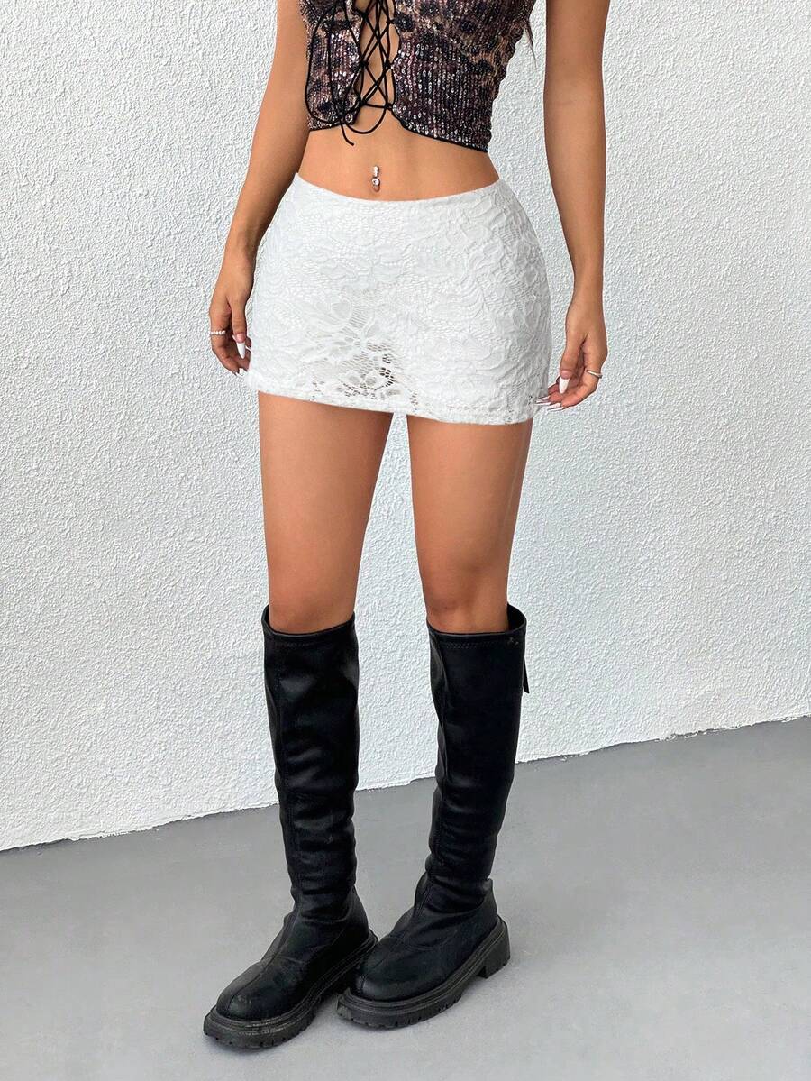 Women's black low waist bodycon mini skirt featuring contrast lace trim, side split detail, and zipper closure.