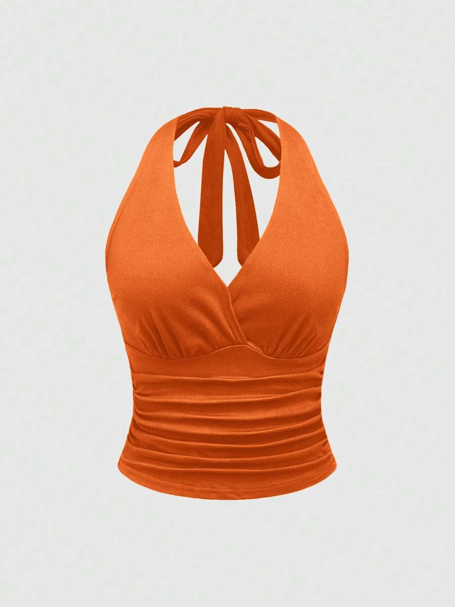 Women's halter crop tank top featuring a backless silhouette and ruched detailing in a slim fit design.