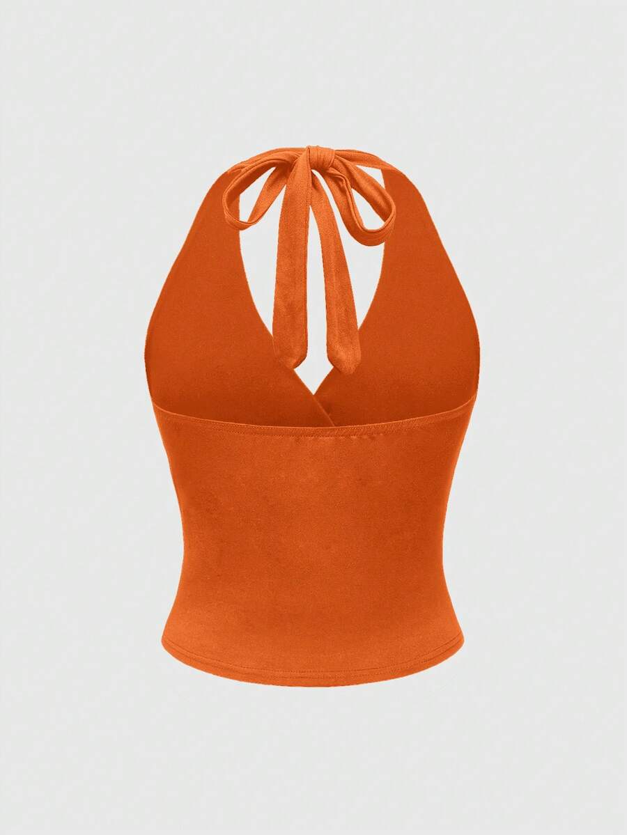 Women's halter crop tank top featuring a backless silhouette and ruched detailing in a slim fit design.