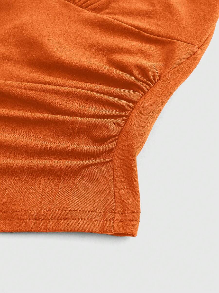 Women's halter crop tank top featuring a backless silhouette and ruched detailing in a slim fit design.