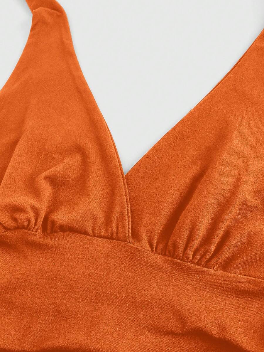 Women's halter crop tank top featuring a backless silhouette and ruched detailing in a slim fit design.