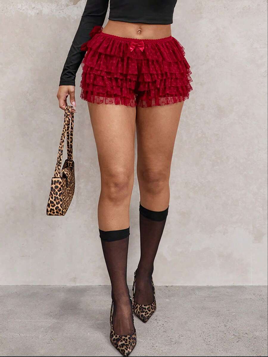 Apricot tiered lace ruffle hem low waist shorts for women featuring elastic waist and lined semi-sheer knit fabric.