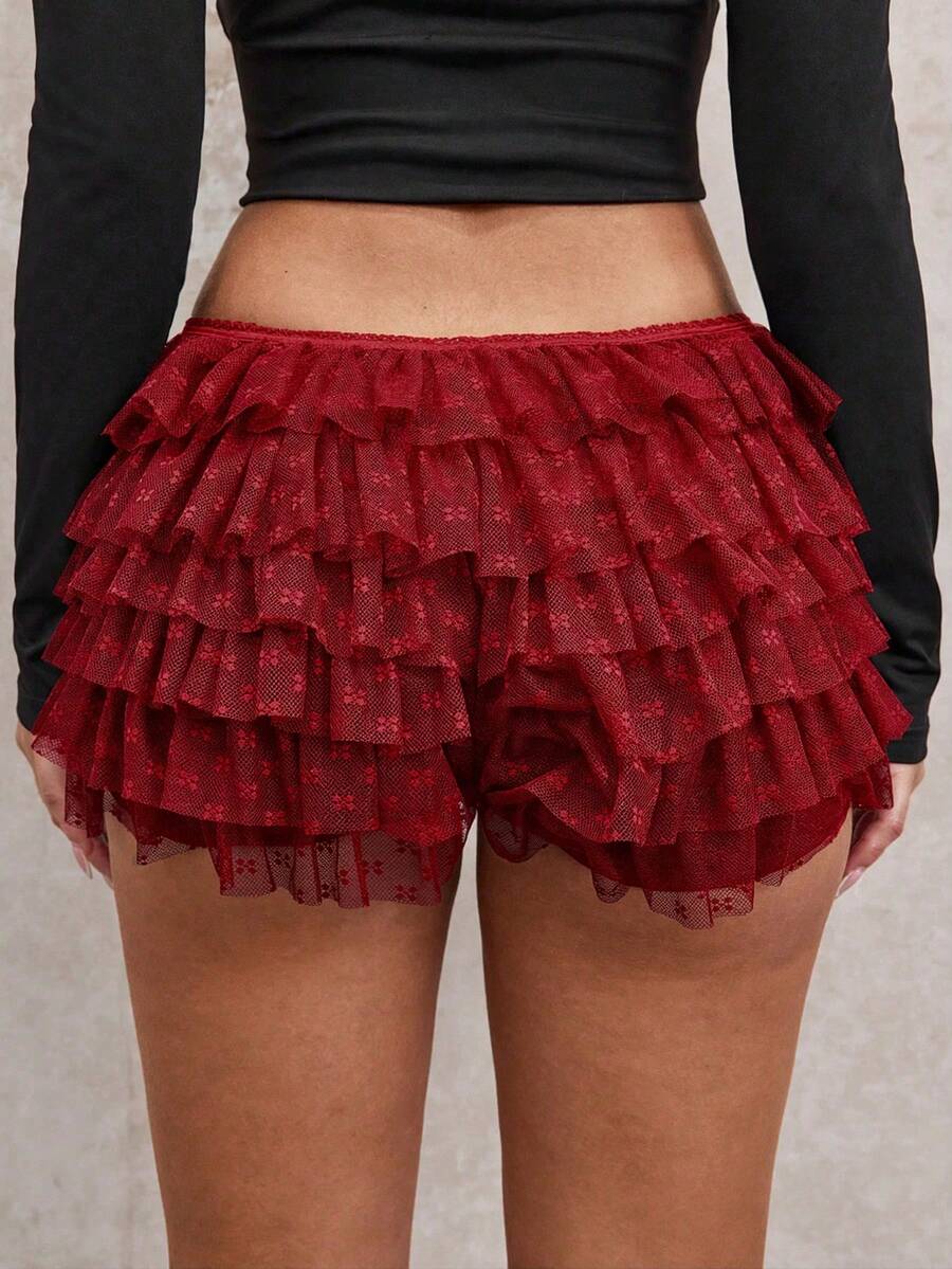 Apricot tiered lace ruffle hem low waist shorts for women featuring elastic waist and lined semi-sheer knit fabric.
