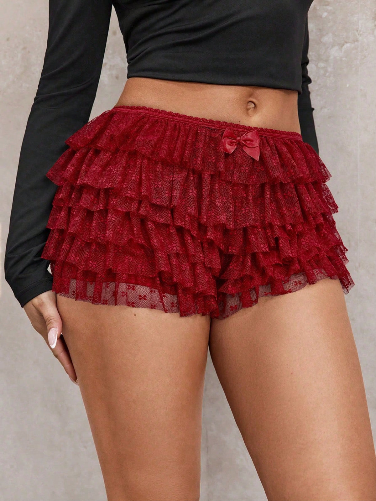 Apricot tiered lace ruffle hem low waist shorts for women featuring elastic waist and lined semi-sheer knit fabric.