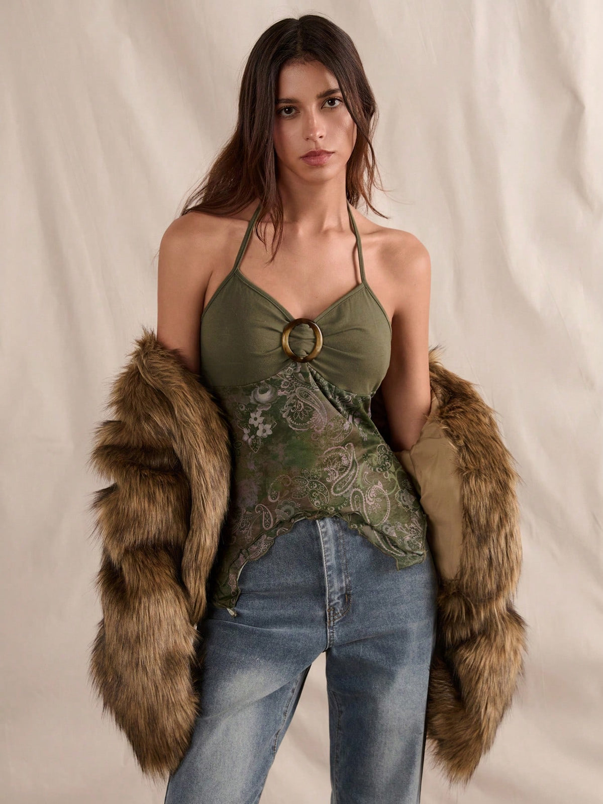 Women's backless halter cami top featuring a paisley print, sleeveless design, and an asymmetrical hem in knitted fabric.