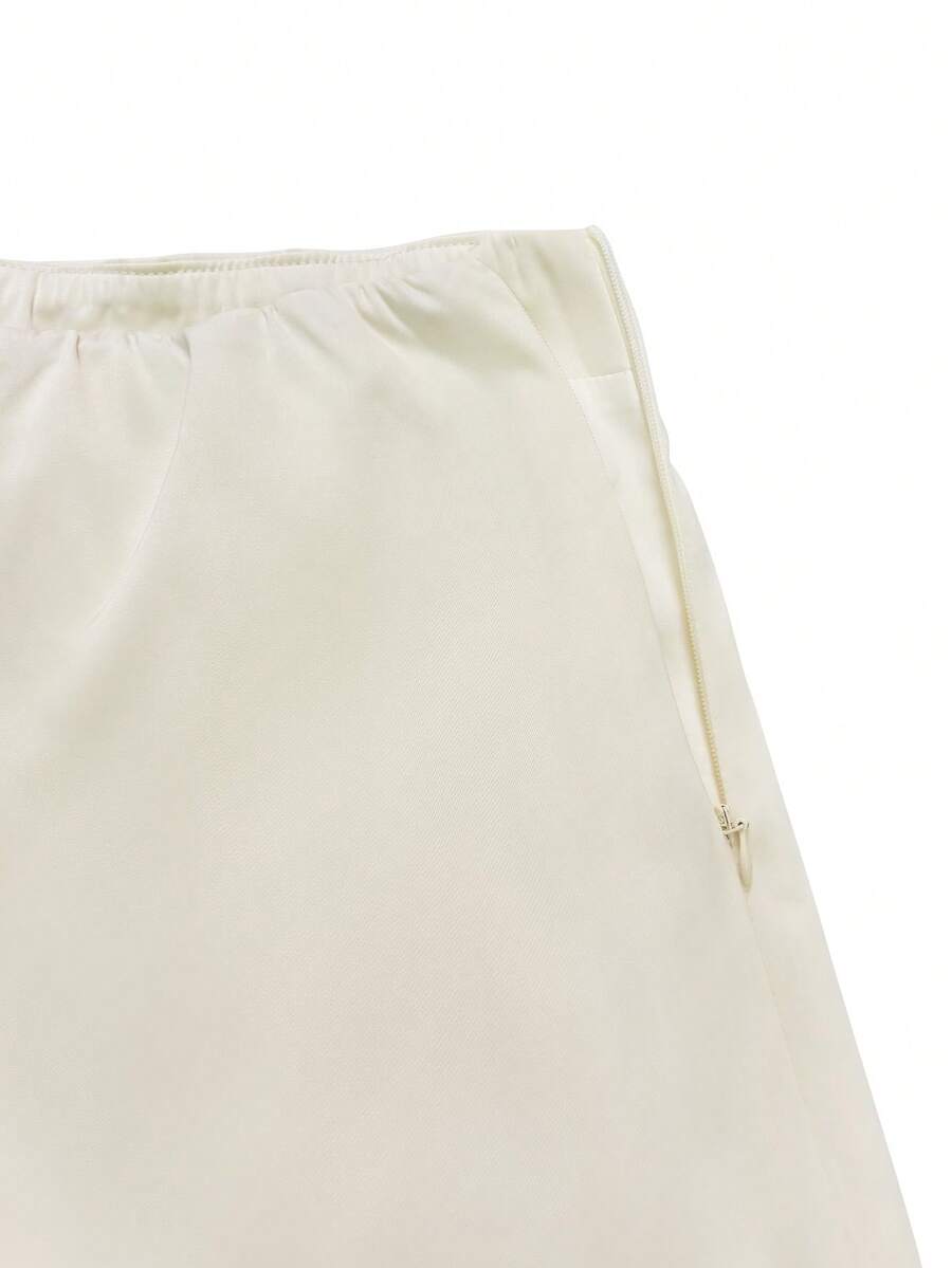 Elegant apricot long satin straight skirt for women featuring an asymmetrical split detail and mid waist fit.