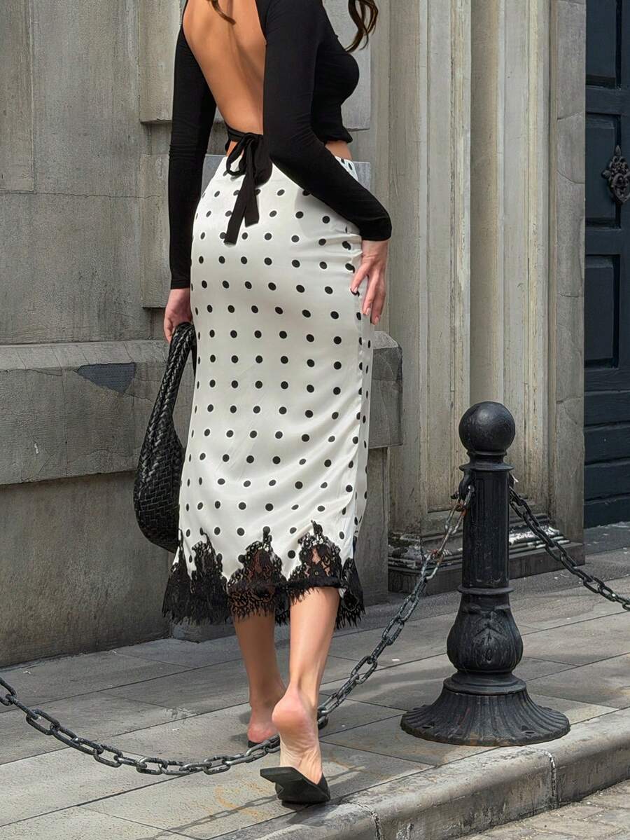 Women's apricot satin flared long skirt featuring contrast lace details, hollow out accents, polka dot pattern, and a low waist regular fit.