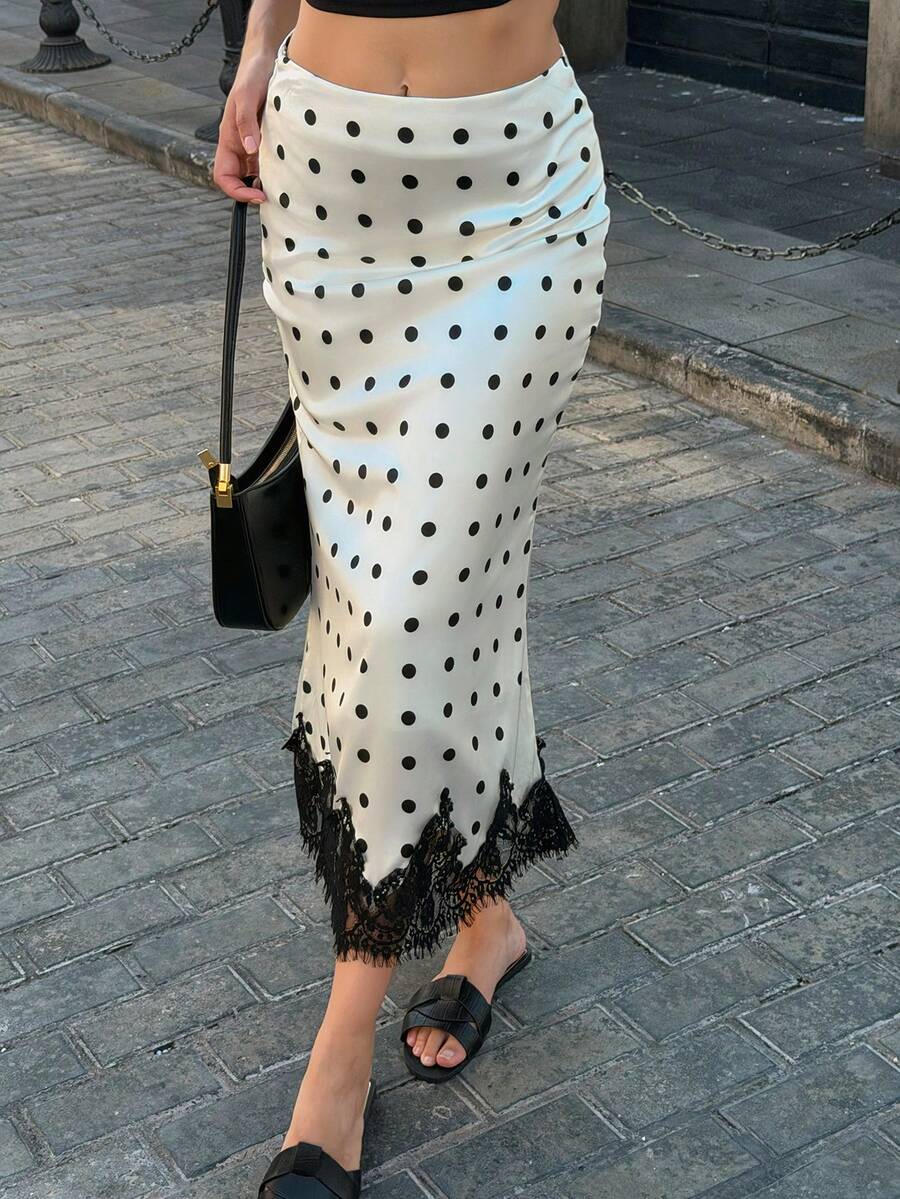 Women's apricot satin flared long skirt featuring contrast lace details, hollow out accents, polka dot pattern, and a low waist regular fit.