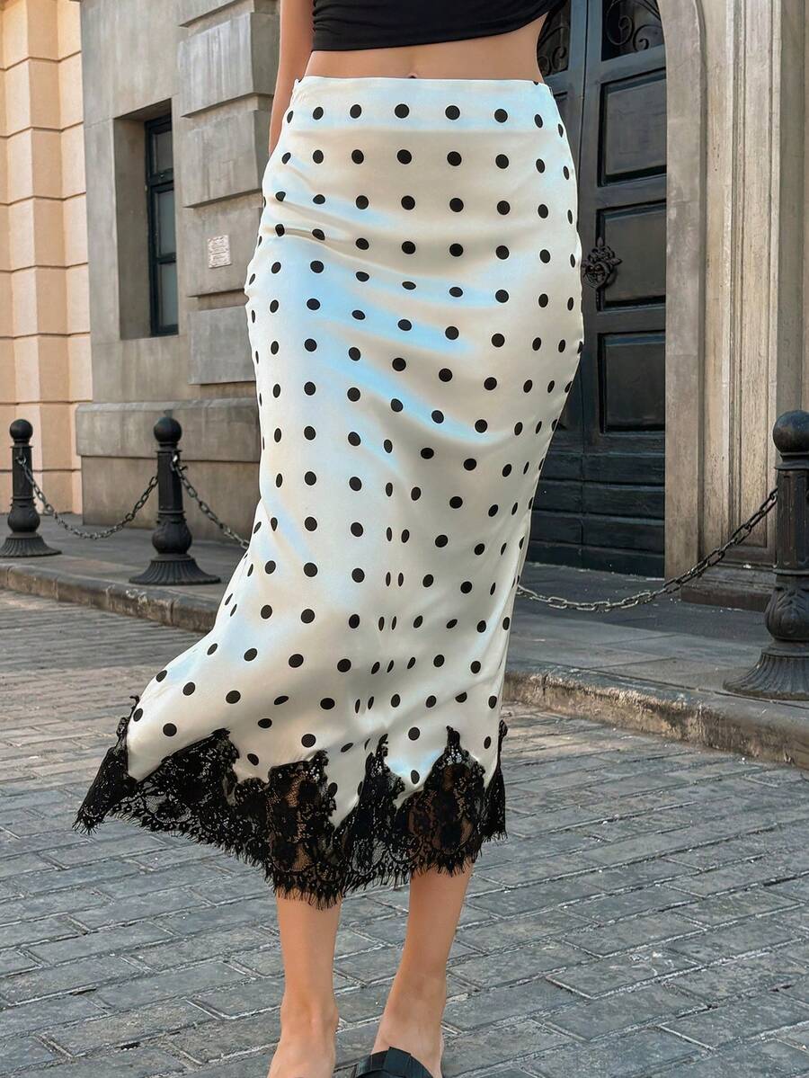 Women's apricot satin flared long skirt featuring contrast lace details, hollow out accents, polka dot pattern, and a low waist regular fit.