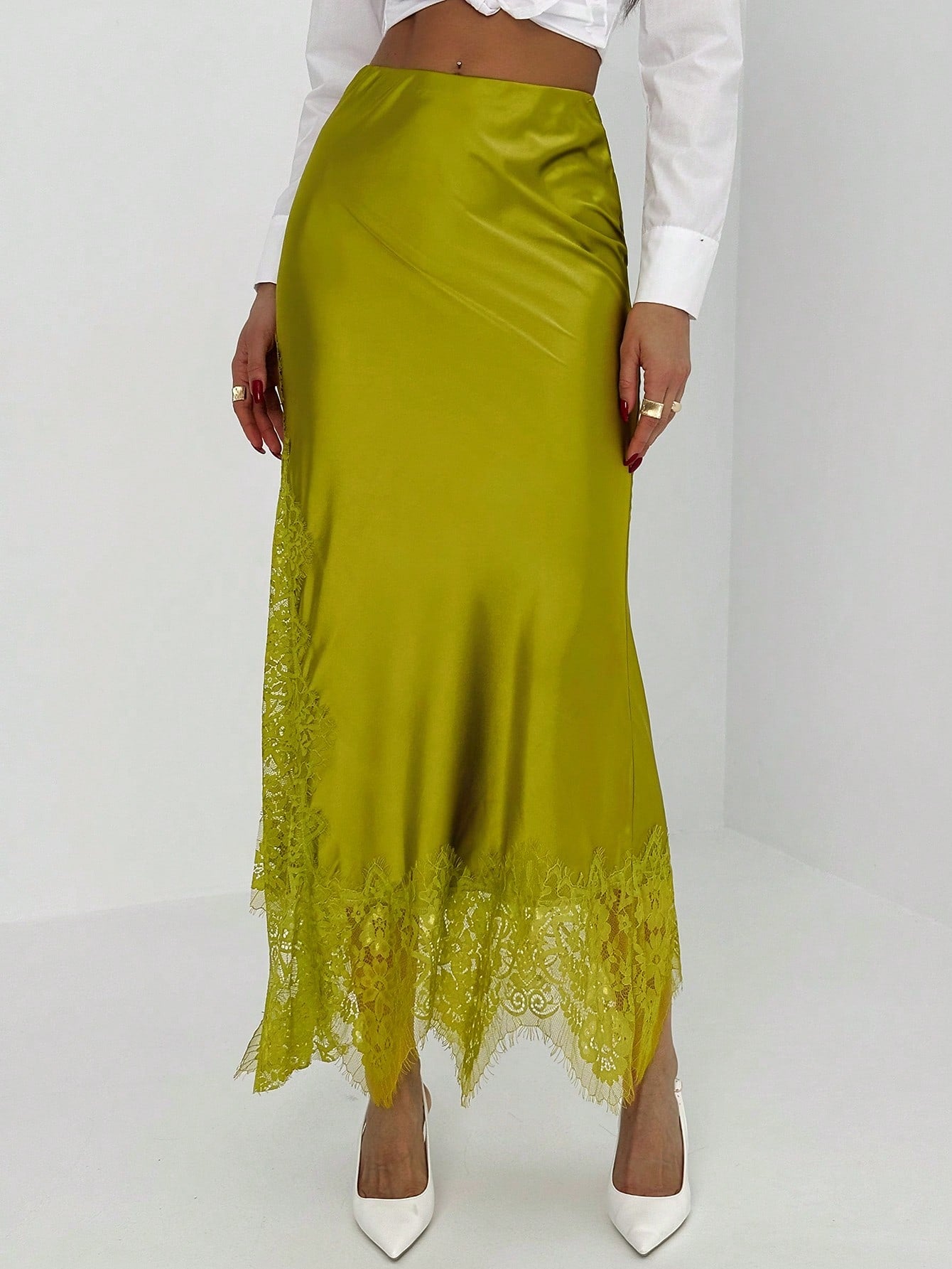 Women's elegant black lace patchwork mermaid maxi skirt featuring asymmetrical contrast lace design and low waist fit.