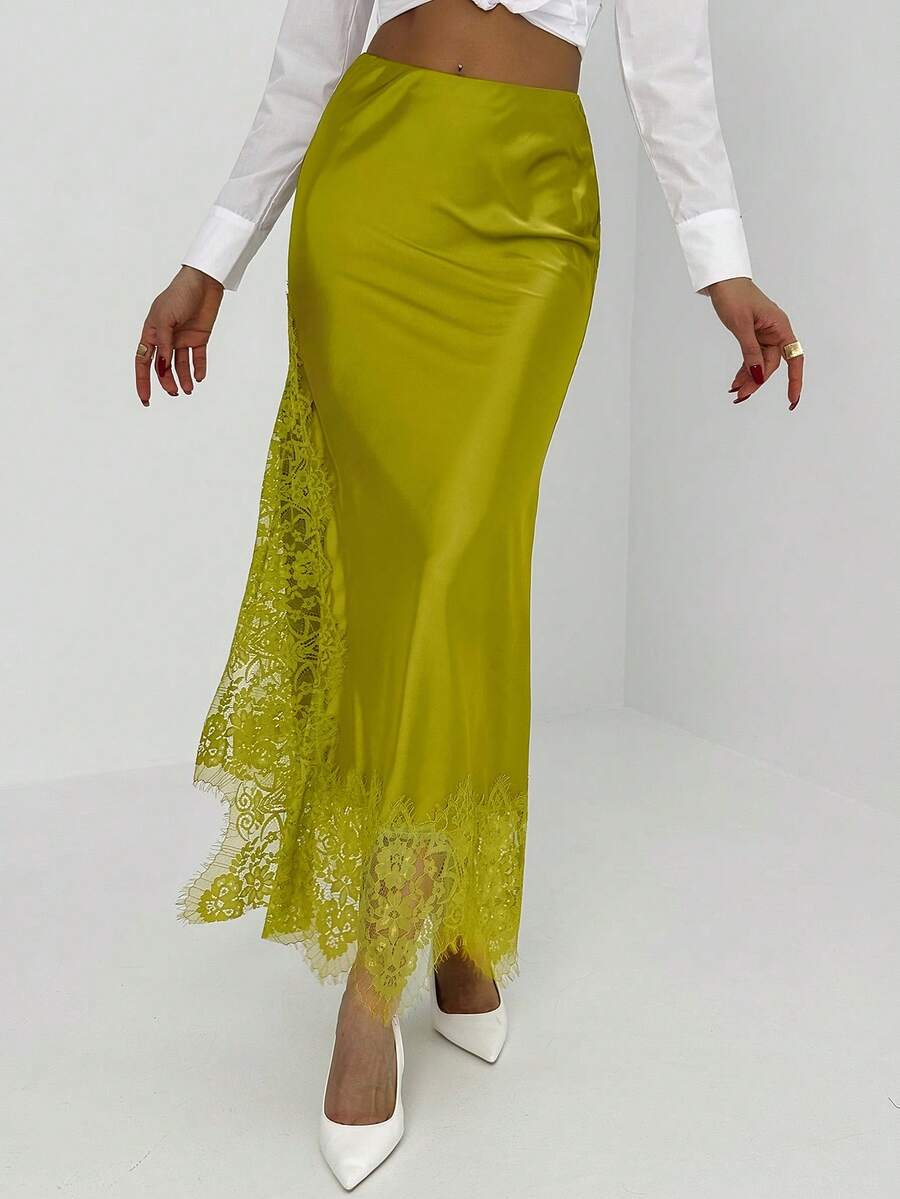 Women's elegant black lace patchwork mermaid maxi skirt featuring asymmetrical contrast lace design and low waist fit.