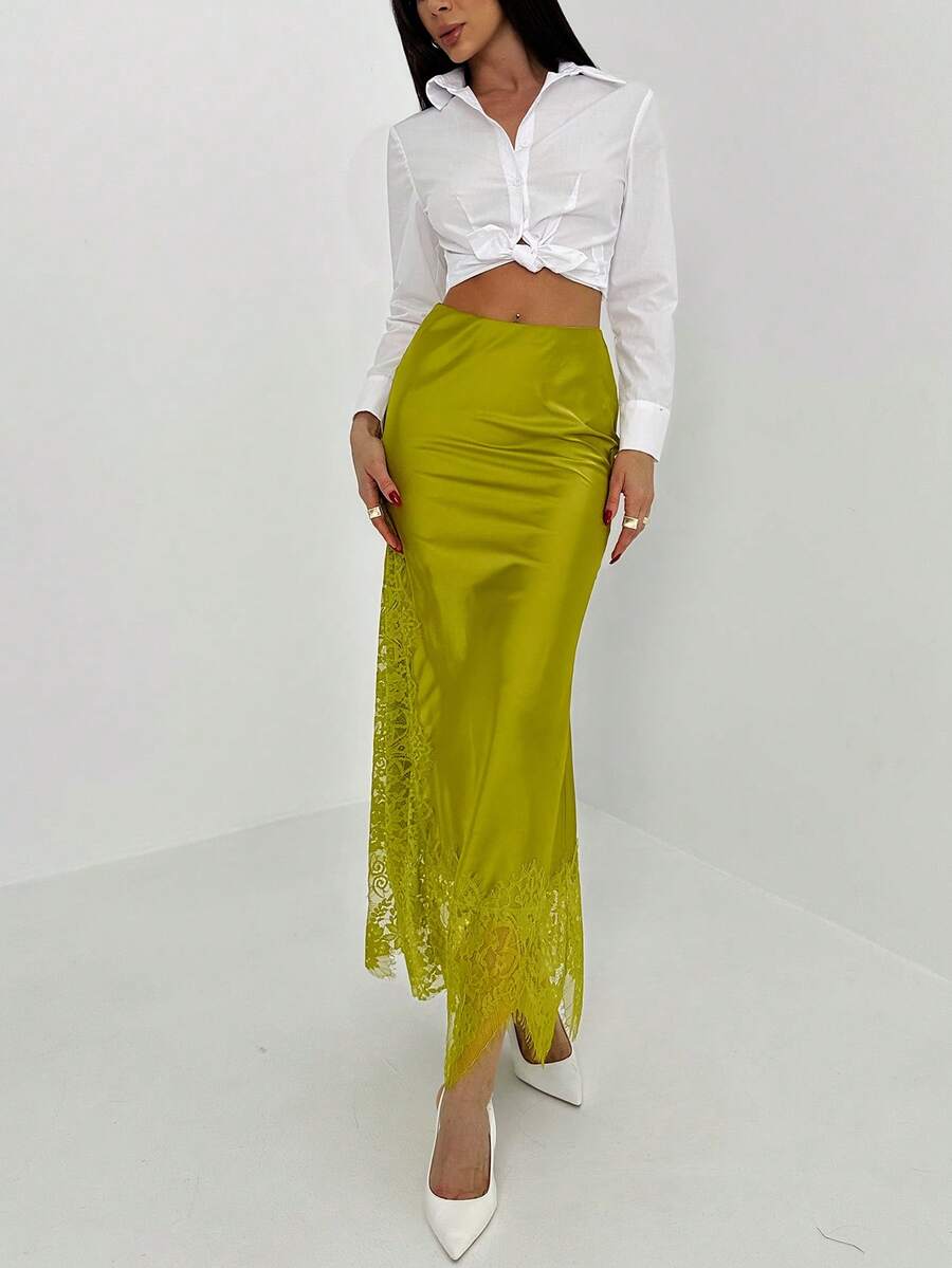 Women's elegant black lace patchwork mermaid maxi skirt featuring asymmetrical contrast lace design and low waist fit.