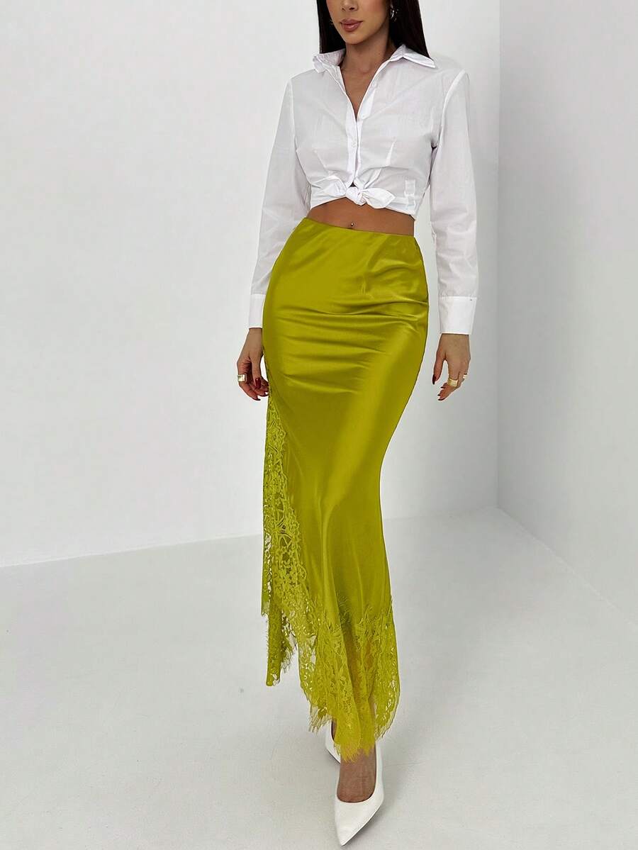 Women's elegant black lace patchwork mermaid maxi skirt featuring asymmetrical contrast lace design and low waist fit.