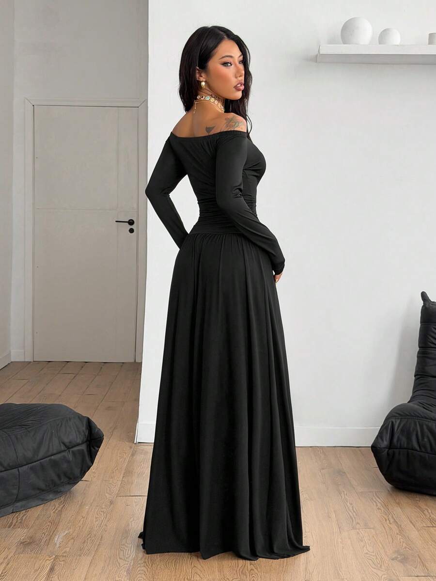 Women wearing a brown off the shoulder maxi dress with asymmetrical ruched cut out details and wrist-length sleeves in a slim fit flared A-line design.