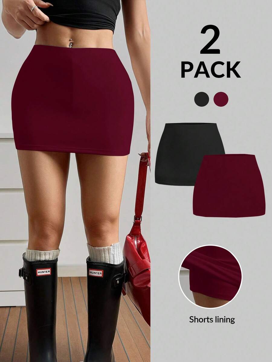 Women's black casual low rise bodycon mini skort with built-in shorts in knitted plain stretch fabric.