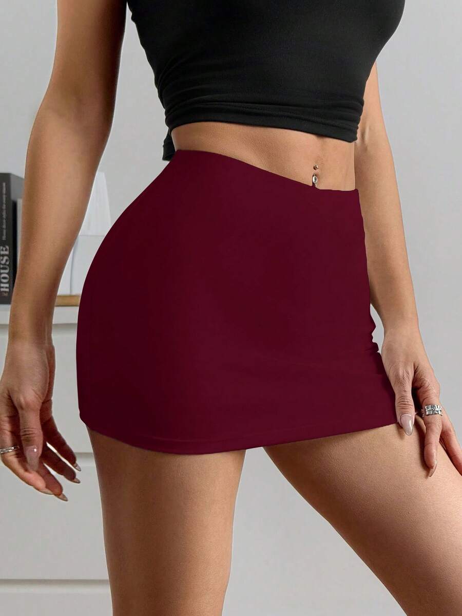 Women's black casual low rise bodycon mini skort with built-in shorts in knitted plain stretch fabric.
