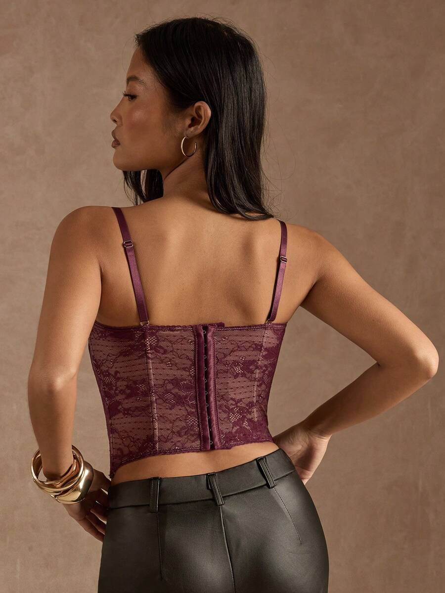 Women’s camisole top with cup detail, spaghetti straps, lined body, and slim fit design in knitted fabric with an asymmetrical hem.