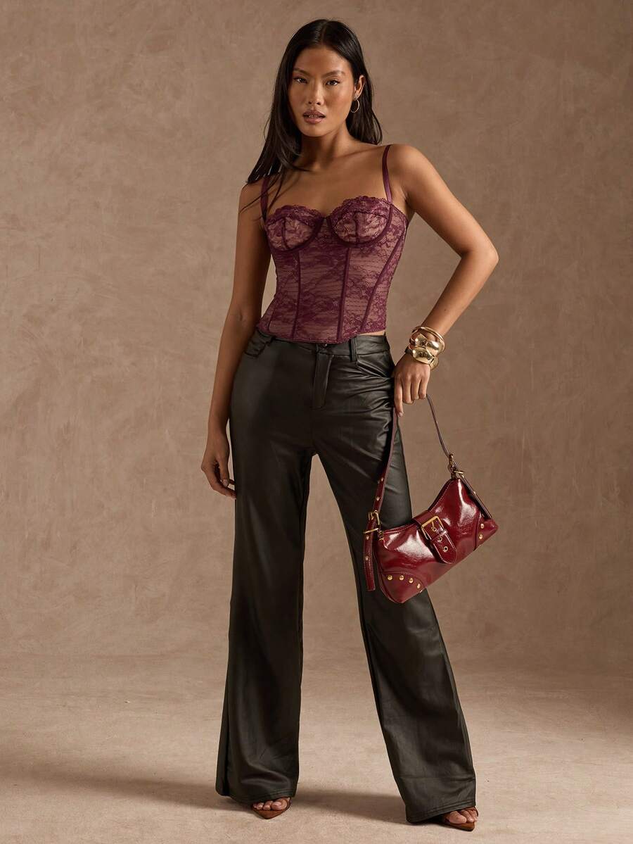 Black women’s lace cami top with spaghetti straps, contrast lace details, and an asymmetrical hem, styled as a slim-fit lined casual top.