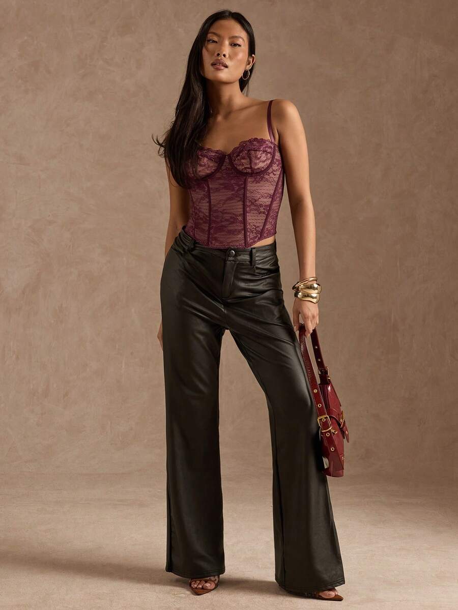 Black women’s lace cami top with spaghetti straps, contrast lace details, and an asymmetrical hem, styled as a slim-fit lined casual top.