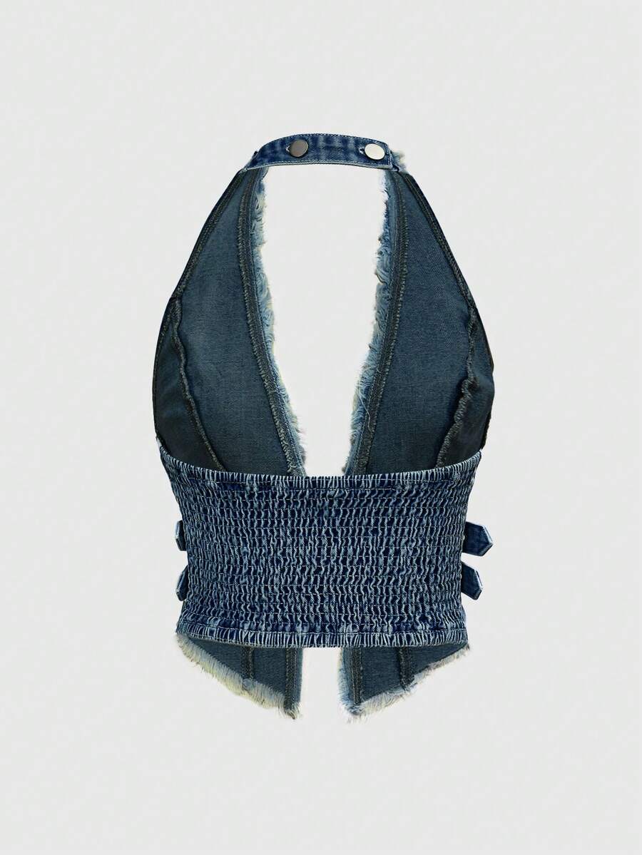 Women's denim halter crop top featuring a backless design, asymmetrical hem, single-breasted front, and lettuce trim.