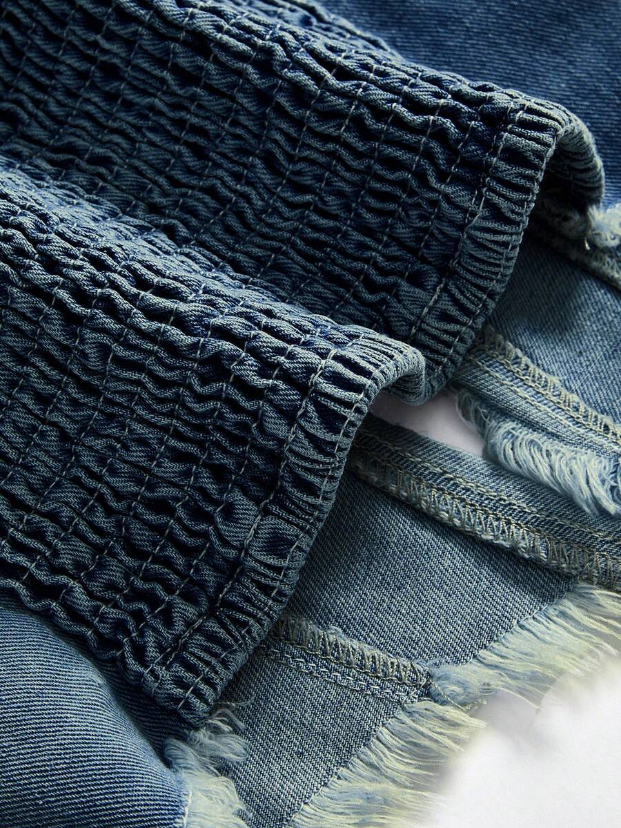 Women's denim halter crop top featuring a backless design, asymmetrical hem, single-breasted front, and lettuce trim.