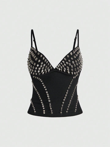 Front view of a black women's dark grunge camisole top featuring rivet studs, rhinestones, sequin details, spaghetti straps, and a slim fit.