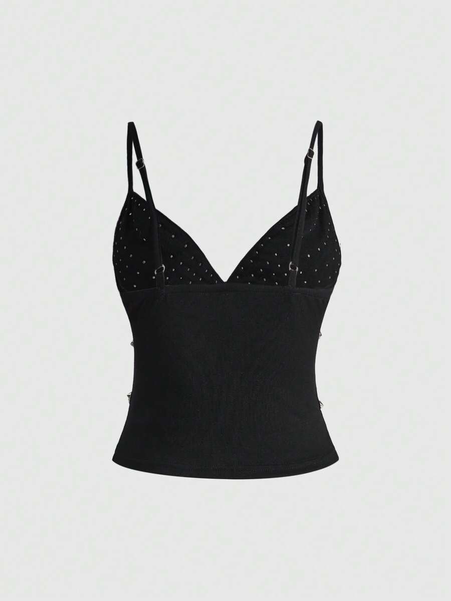 Front view of a black women's dark grunge camisole top featuring rivet studs, rhinestones, sequin details, spaghetti straps, and a slim fit.