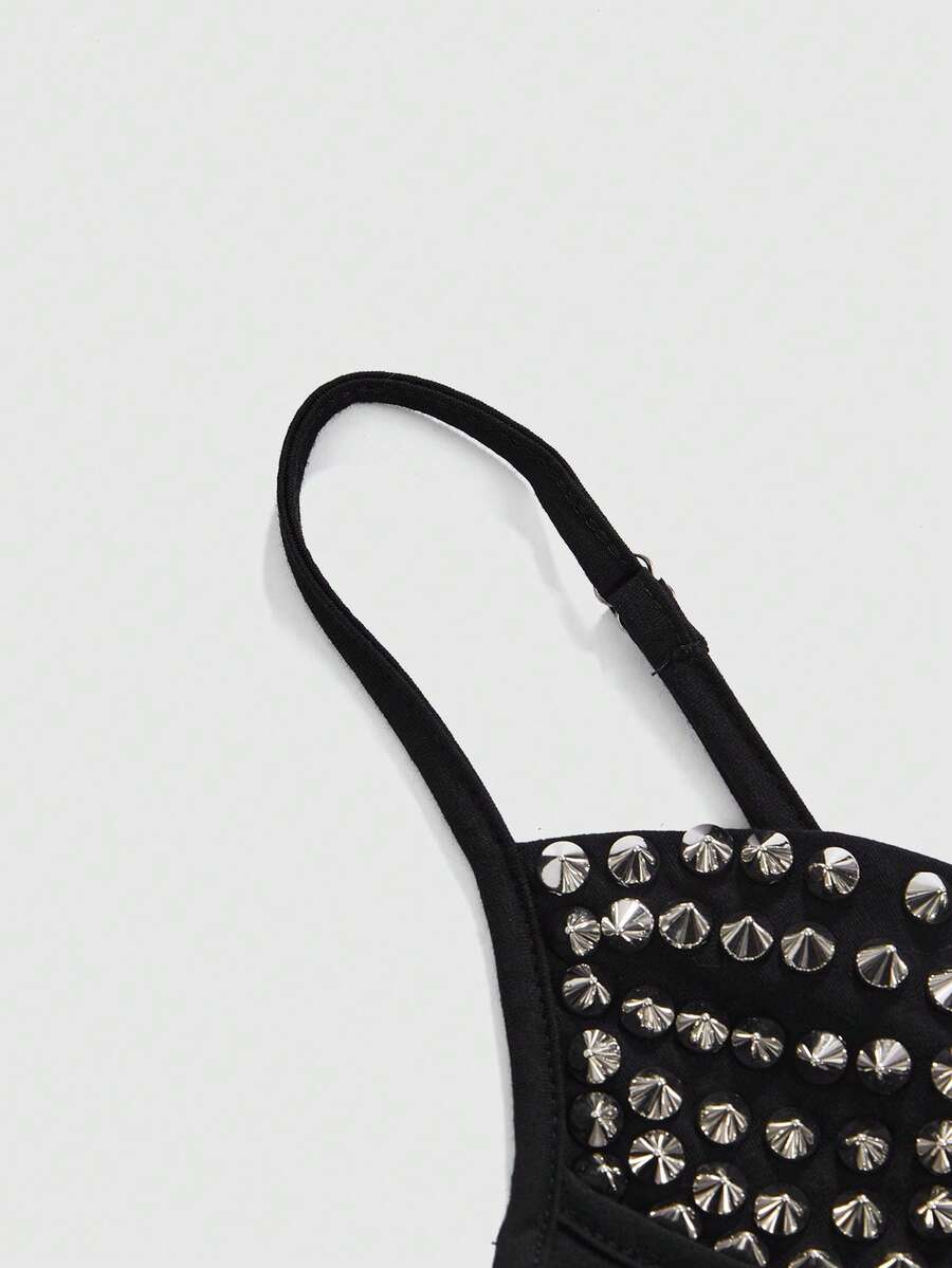 Front view of a black women's dark grunge camisole top featuring rivet studs, rhinestones, sequin details, spaghetti straps, and a slim fit.