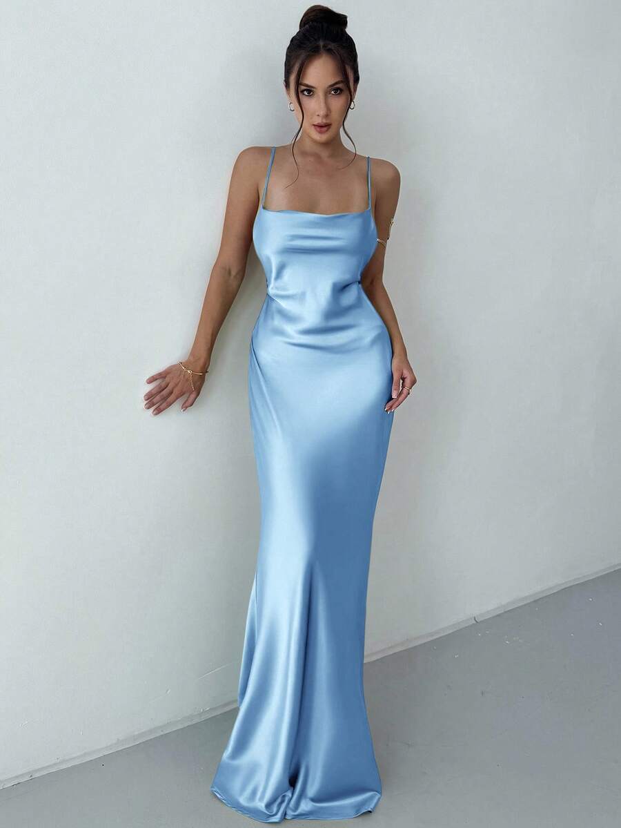 Beige satin backless maxi dress featuring criss-cross spaghetti straps and a mermaid hemline.
