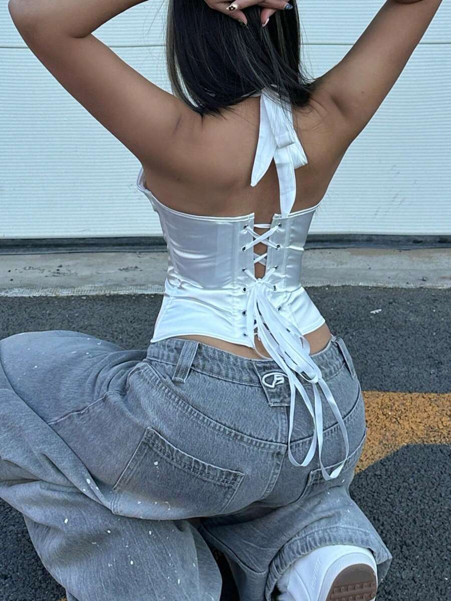 White satin corset crop top featuring a halter neck, slim fit, and back lace-up design.