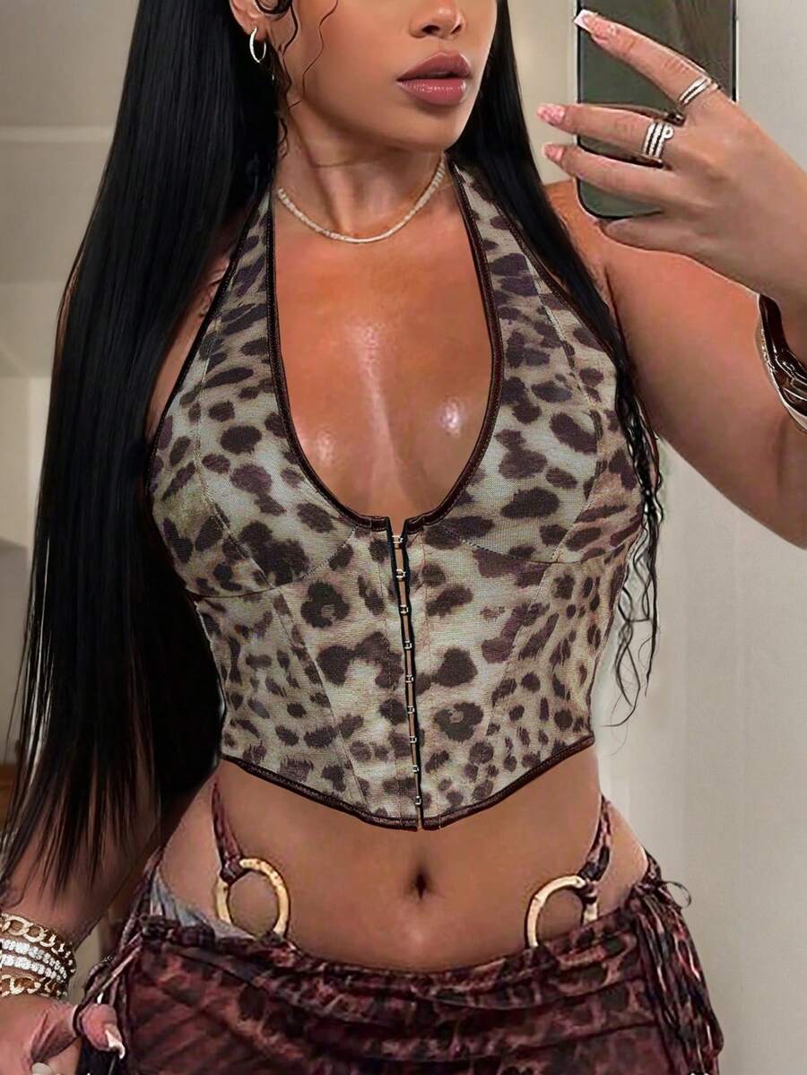 Women's leopard print backless camisole crop top with halter neckline and asymmetrical hem.