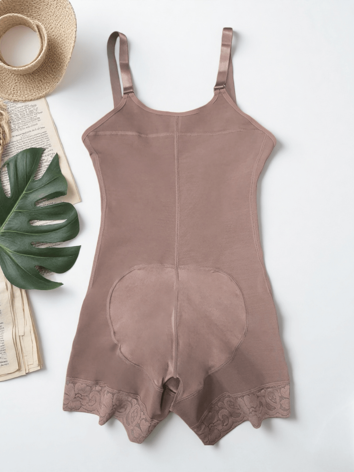 Women's apricot body shaper jumpsuit with 4-row hook and eye front closure and contrast lace details.