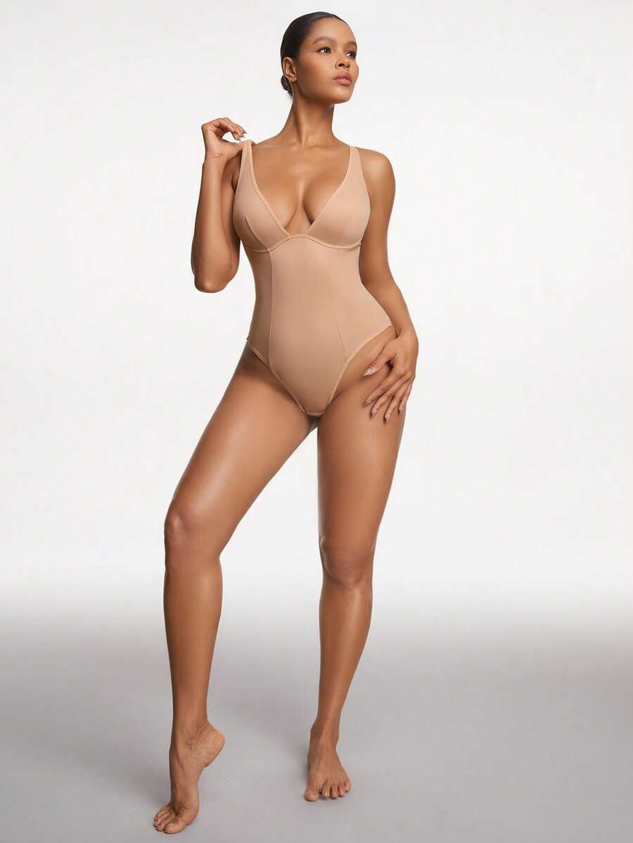 Apricot backless shapewear bodysuit with thong cut, cup details, and high-stretch fabric for light tummy support.