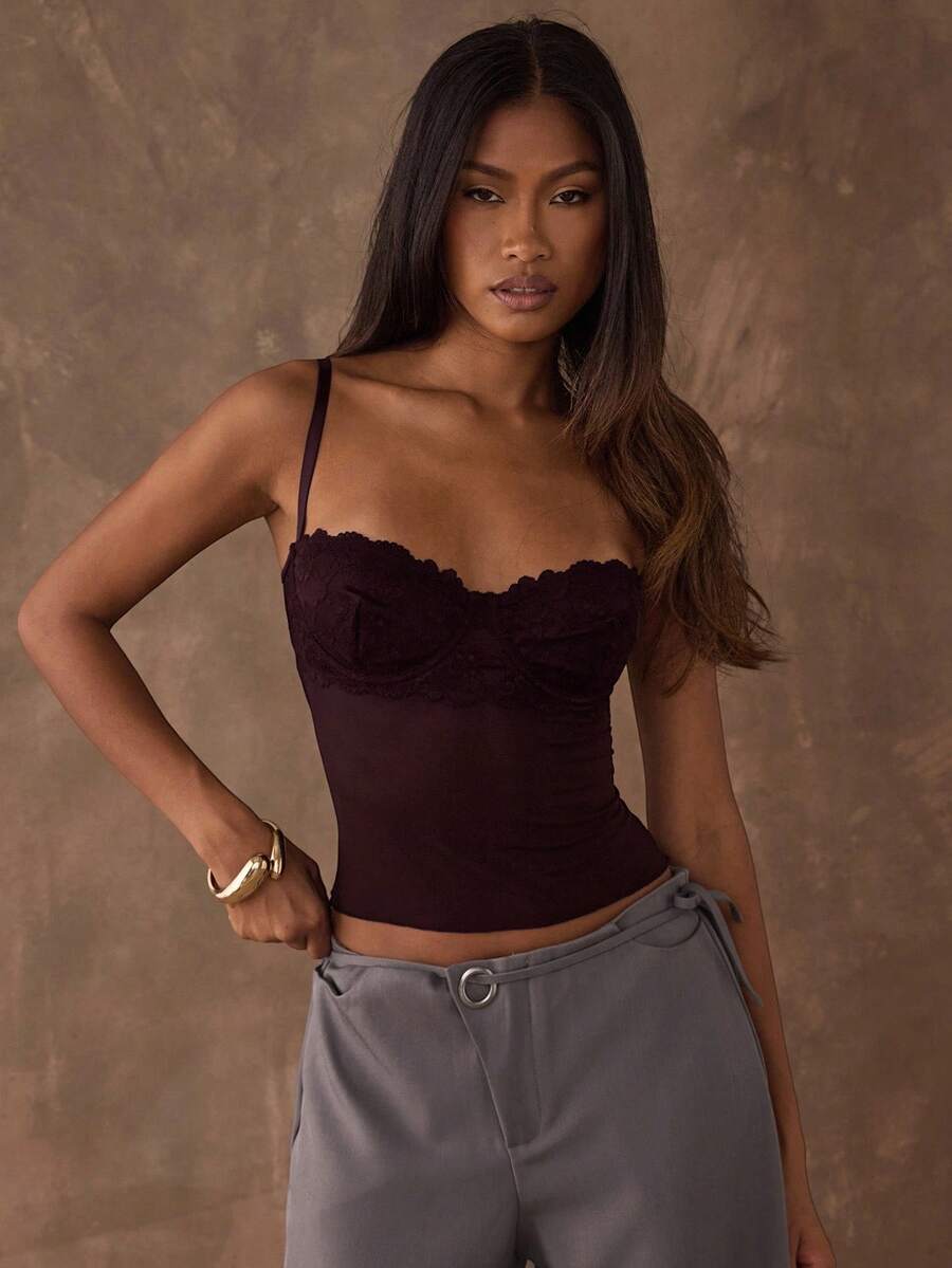 Women's black contrast lace camisole with spaghetti straps, cup detail, semi-sheer finish, and slim fit for going out or date night.