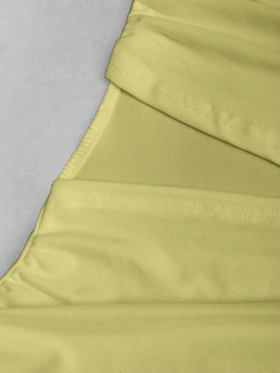Women's black strapless bodycon mini dress featuring ruched detailing, cut-out design with ring accent, mid-waist pencil hem, and slim fit knitted stretch fabric.