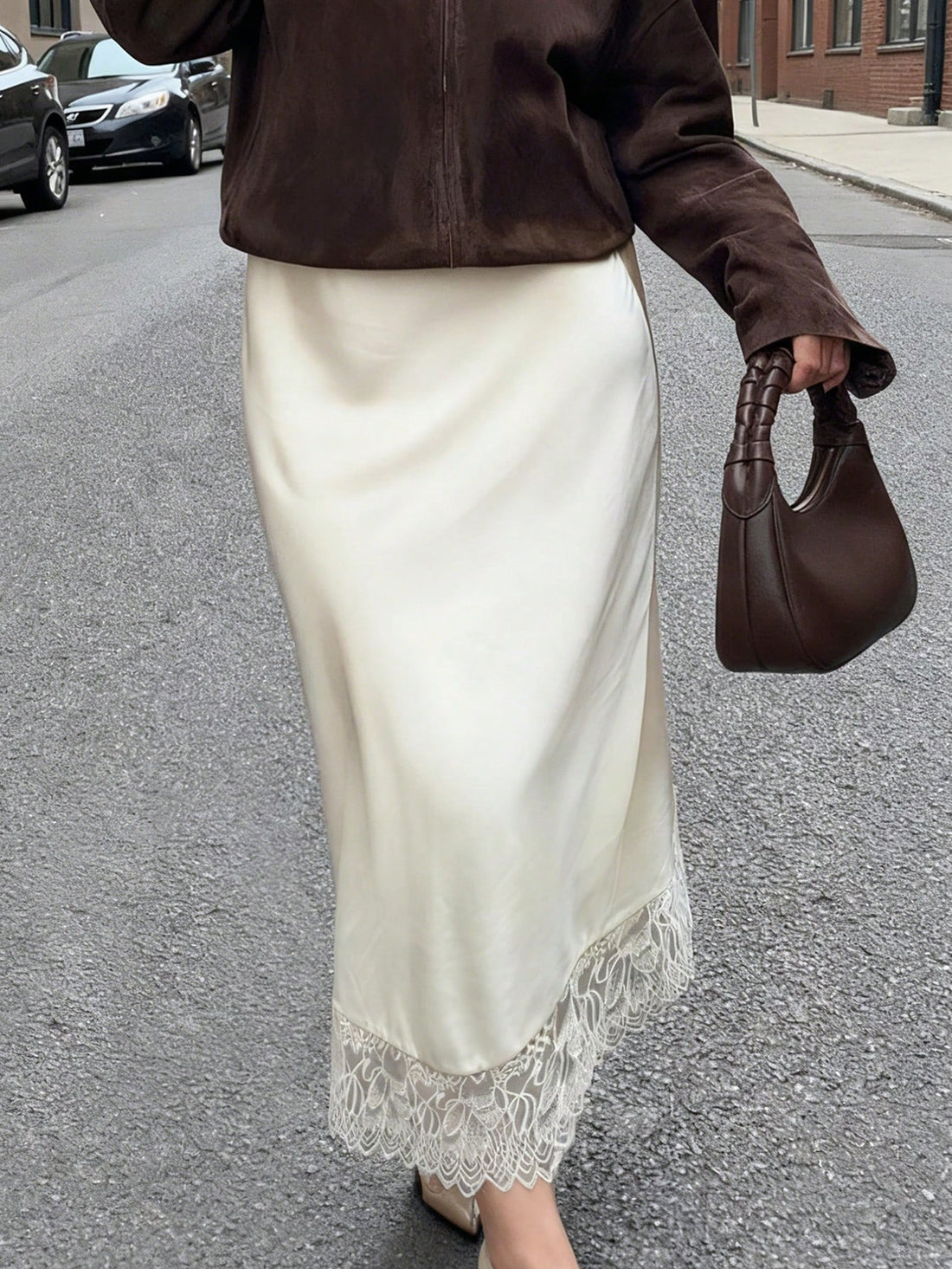 Elegant apricot long satin straight skirt for women featuring an asymmetrical split detail and mid waist fit.