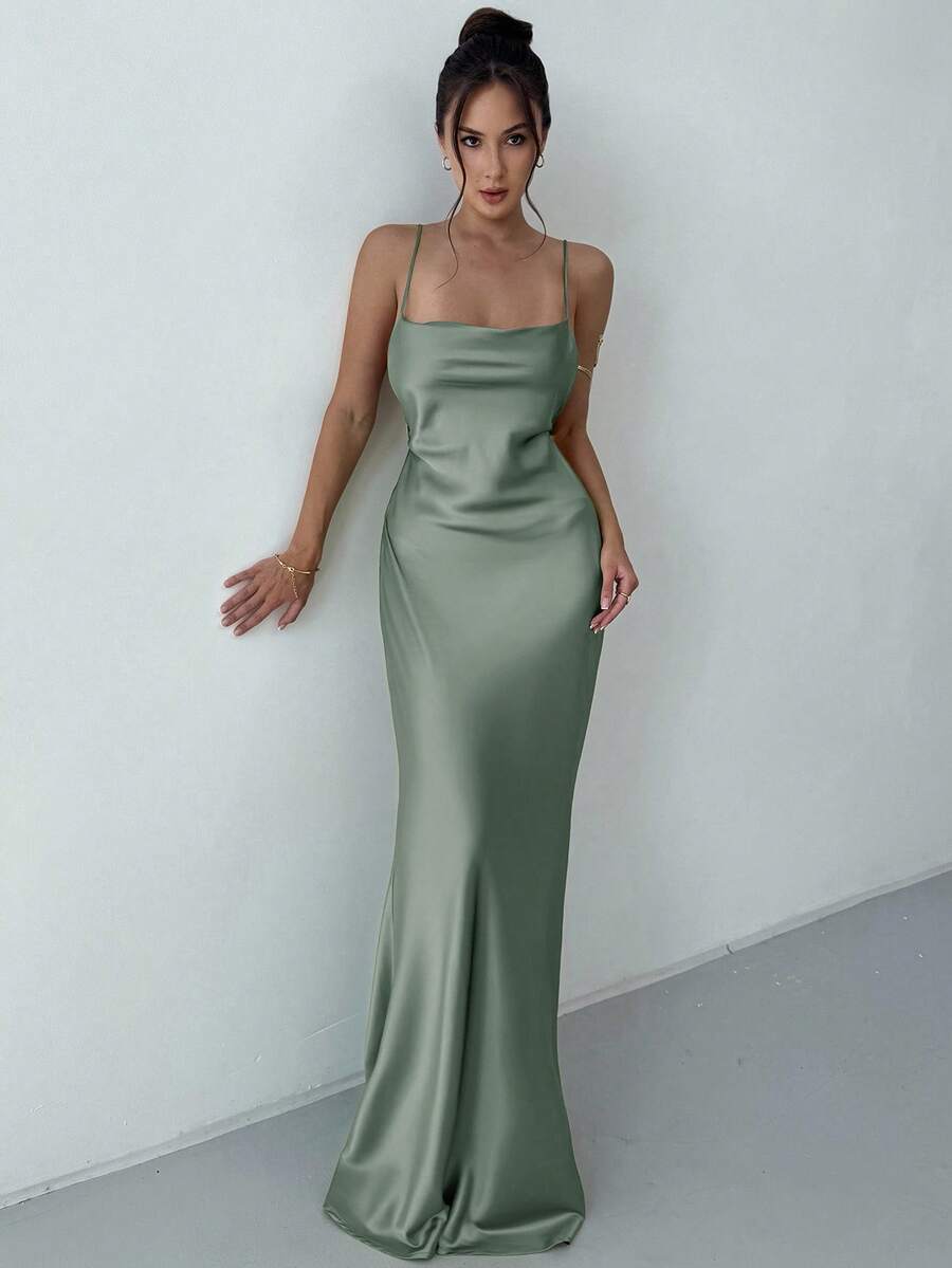 Beige satin backless maxi dress featuring criss-cross spaghetti straps and a mermaid hemline.