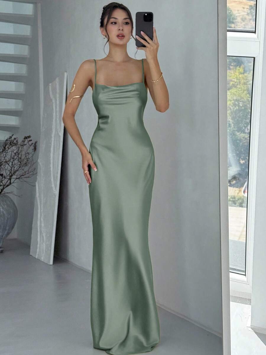 Beige satin backless maxi dress featuring criss-cross spaghetti straps and a mermaid hemline.